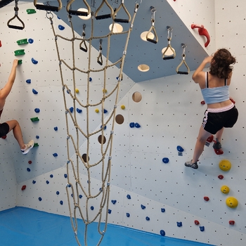 Boulderraum mit zwei Frauen beim Klettern.